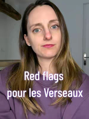 A selfie-style shot of a woman with long brown hair and a purple sweater. Text overlayed on the image reads "Red flags pour les Verseaux" in white text. The woman is facing the camera directly.