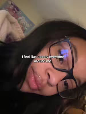 A selfie-style shot of a person with dark hair and glasses, angled up towards the camera. The person has a slight smile, and the text overlay is placed in the middle-upper part of the image against the person's face.