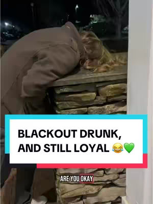 A woman leaning against a stone wall appears to be overwhelmed by intoxication. The overlay text highlights her enduring loyalty.