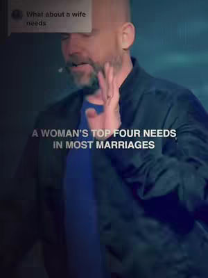 A man in a black jacket is speaking, with text overlays on the screen. The background is a blurred dark blue.