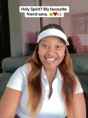 A woman with long brown hair and a white visor smiles at the camera. Text floats above her head. The background is blurred, but appears to be a well-lit interior.