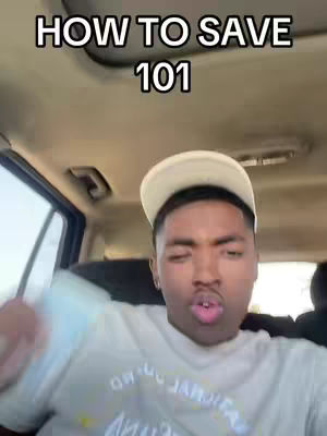 In a selfie-style shot, a young man is seated inside a car. The background shows the car's interior, with seats and windows visible. The man is wearing a white cap and a light-colored t-shirt and his expression suggests he is speaking. Above the man is a bold text overlay in a white font. The overall composition is straightforward, focusing on the man and the message.