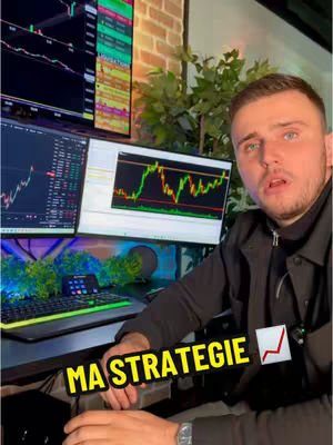 A man is seated in front of a desk with two computer monitors displaying trading charts, a keyboard, and a small device. The hook text is in a yellow box with an upward-pointing arrow.