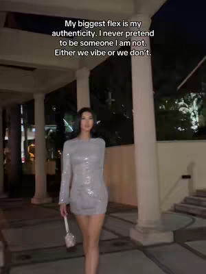 The cover image shows a woman in a silver sequined dress walking towards the camera in an outdoor setting at night. The upper half of her body is visible, and she is holding a small, shiny purse. Text overlays are added at the top.
