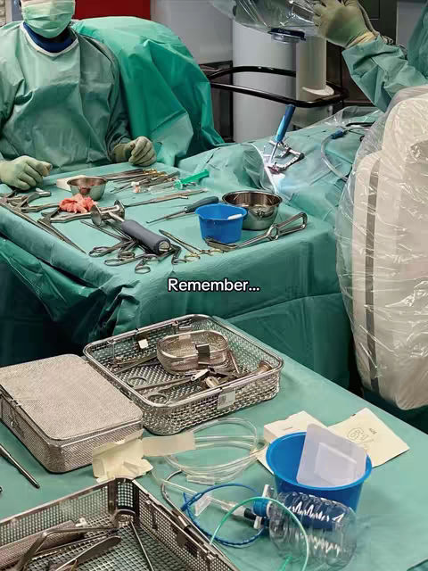The cover image depicts an operating room setting. Two figures in green surgical attire are in view. Various surgical instruments are neatly arranged on a light-green-covered table. A text overlay states Remember...