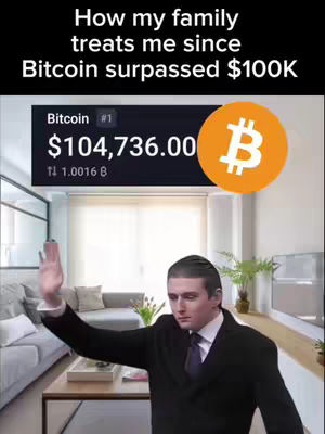 The image is a meme featuring a man in a suit reacting to a Bitcoin price display. The background shows a living room setting. The man is mid-wave, and a Bitcoin logo floats to the right. The text reads "How my family treats me since Bitcoin surpassed $100K". The screen displays Bitcoin's value.
