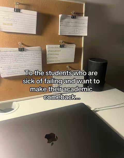 A shot of a desk with flashcards, some attached to a bulletin board with metal clips. The caption text sits at the bottom over the image of a laptop.