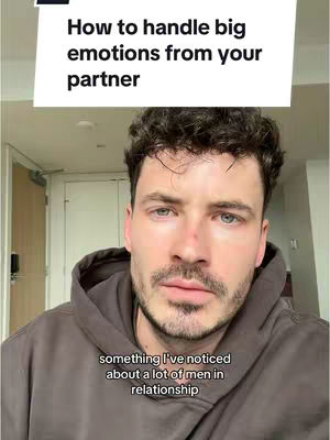 A man in a hoodie is centered in a close-up shot. Above him is a white text box with the video title. Below him, another text box contains additional text relevant to the video.