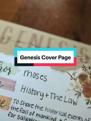 A close-up shot of a notebook page with handwritten text, decorated with torn paper details and floral elements. The text indicates the title "Genesis Cover Page" as a hook with a colorful, overlaid style in different colors, and there is text about "Moses", "history", and "the Law". The background has a blurred, warm tone, possibly of wood.