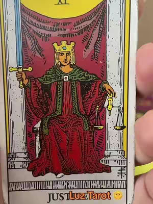 The cover image is a close-up of a tarot card from the Justice deck. It features a person seated in a throne-like chair, wearing a red robe with a green tunic underneath, and a gold crown. The figure holds a sword in one hand and a balance scale in the other. The background is a red curtain, and the overall color scheme is dominated by reds, golds, and greens. At the top of the card, there is a yellow banner with Roman numerals. The bottom of the card has some text. The card has a border.
