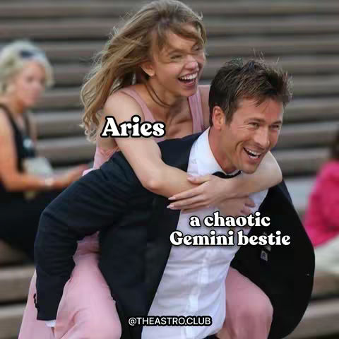 A meme-style image featuring a man carrying a woman piggyback style, both laughing. Text overlays label the woman as 'Aries' and the man as 'a chaotic Gemini bestie'. The background appears to be a blurred outdoor setting, possibly a formal event.