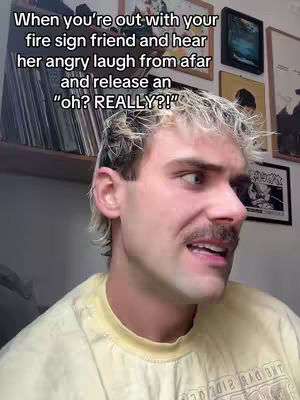 The cover image shows a man in a yellow shirt with a surprised expression, his eyes looking to the side. There are framed images on the wall behind him and a stack of records on a shelf.