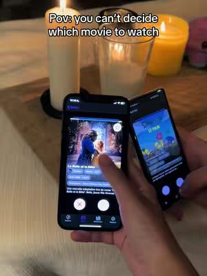 The cover image shows two smartphones in front of a table setting with candles and glasses. The phone on the left displays an image of a movie scene, while the phone on the right shows an app interface. The phone are held by a person, hands are visible in the view.