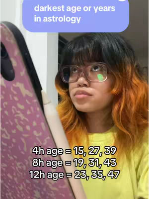 A young woman with black hair, orange highlights and glasses is holding a phone while looking upwards. A text box above her head states "darkest age or years in astrology". Along the bottom of the frame are the details of different age breakdowns.