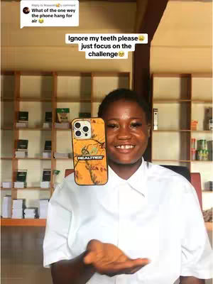 A young woman in a white shirt and a patterned phone case holds a phone over her open palm, standing in front of shelves stocked with products. Text overlays comment on her teeth and the challenge.