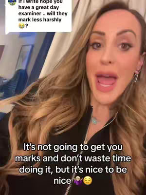 A selfie-style video features a woman with long, wavy blonde hair. She's positioned at a slight angle, looking directly at the camera with her mouth open in a speaking expression. Text overlays appear in the frame, and she's dressed in a black top.