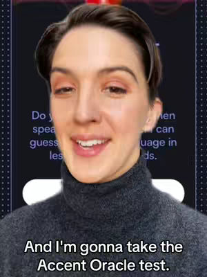 A woman with short brown hair and fair skin is centered in the frame, looking directly at the camera and smiling slightly. She wears a dark gray turtleneck sweater. The background includes text overlay on a dark screen and a framed border.
