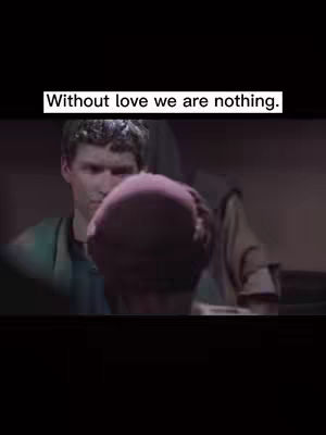 Image of a man looking down on a person as if comforting them. Text overlay at the top says 'Without love we are nothing.'