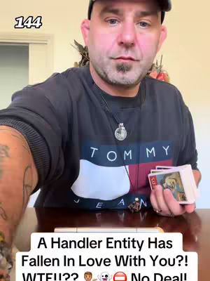 A medium shot of a man, positioned from chest up, holding a deck of cards and looking directly at the camera. He is wearing a black t-shirt with a white TOMMY logo and a black cap. A portion of a colorful tattoo is visible on his left arm. The background is a blurred interior setting, likely a part of a room. Overlay text at the bottom features a question and exclamations.