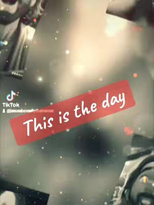 The image features a blurred, grayscale background with subtle sparkles. Overlaid on the background is a red rectangular banner containing the white text "This is the day."
