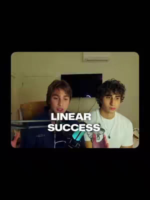 The cover image shows two young men in a well-lit room, likely a home setting. They are positioned next to each other, with the one on the left slightly closer to the camera, and both appear to be engaged in speaking or listening attentively. The one on the right is wearing a white t-shirt, and both appear to be in their twenties. In the background, a dark screen suggests a TV, and the overall composition is typical of a vlog or conversational-style video.
