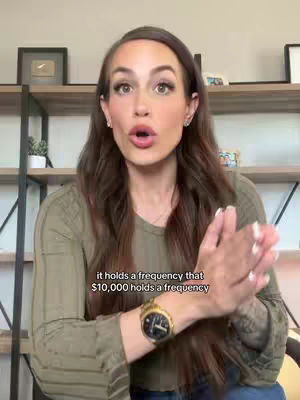 A woman with long brown hair and minimal makeup is speaking, gesturing with her hands, and displaying text overlays on her image.