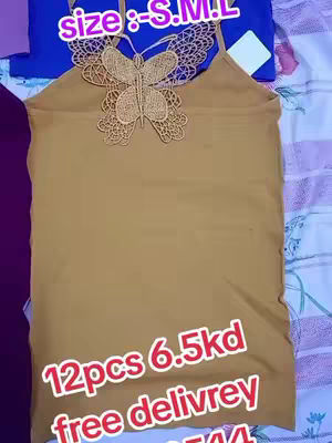 The image showcases a mustard-colored camisole featuring a decorative butterfly applique. The top is placed on a surface covered with a patterned fabric, with a vibrant blue and purple fabric visible in the background. Text overlays provide pricing and sizing information.