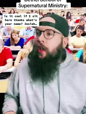 A man with a beard and glasses is in a room with many other people. Text is overlayed, suggesting a humorous or religious discussion.