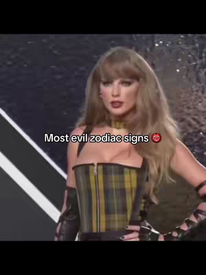 The cover image shows Taylor Swift in a glamorous setting, likely during an awards show or performance. She's wearing a plaid corset-style top, a dark choker, and has her hair styled with bangs. Text overlay, identifying the content, reads "Most evil zodiac signs".