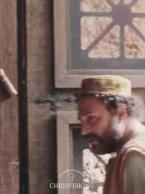 The image shows a man in a traditional hat looking downwards, possibly in thought or contemplation. The background is blurred but seems to be a simple wooden wall. There is a small logo in the bottom-center of the frame that reads 'CHRISTISKING'.