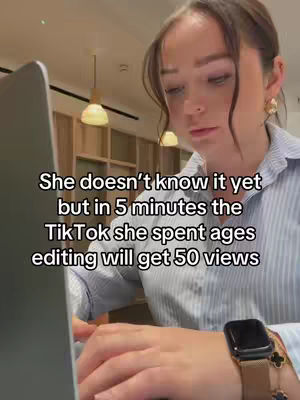 A woman in a striped shirt is working on a laptop. Text overlayed describes a TikTok video getting low views.