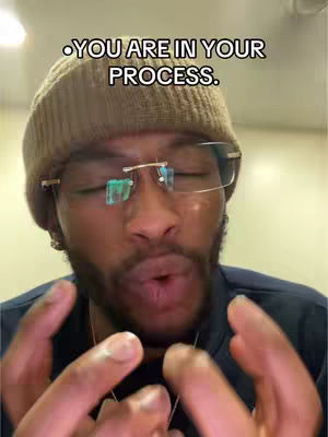 A man with a beard, wearing a brown beanie and glasses, appears to be speaking. Text overlaid on the image says, 'YOU ARE IN YOUR PROCESS.'