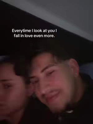 A cover image showing two individuals face close-ups, both with dark hair and a slightly blurred background. Text at the top reads: 'Everytime I look at you I fall in love even more'. The composition focuses on the faces, giving a sense of intimacy or a personal message.