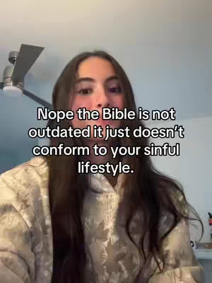 The image features a woman with long brown hair, looking directly at the camera. She is wearing a patterned top. Overlayed on the image is white text.