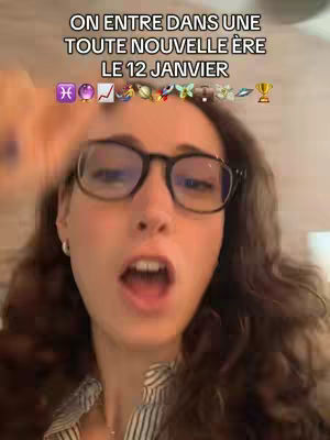 The cover image shows a woman with long, wavy brown hair and glasses looking directly at the camera with her mouth open. Above her head is a text overlay with the phrase "ON ENTRE DANS UNE TOUTE NOUVELLE ÈRE LE 12 JANVIER" followed by a string of emojis. The background is blurred, suggesting an interior setting.