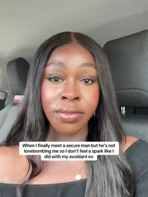 A selfie-style shot of a woman seated in a car. She has long, dark hair and is looking towards the camera with a neutral expression. The image is framed from the chest up, with the car's interior visible in the background, including the headrest of the car seat providing a backdrop. A text overlay appears at the bottom, describing a relationship scenario. The lighting is natural, and the overall composition is simple.