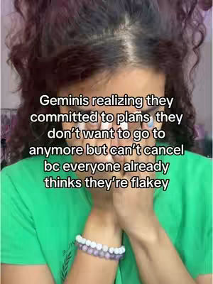 A person with dark curly hair is seen from the chest up, hands covering their face, green shirt and a bracelet, and a text overlay in white font. The overall tone is one of introspection or slight distress.