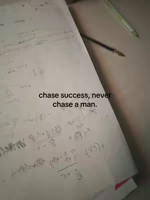 A photo of a sheet of paper with handwritten math equations and the text overlayed 'chase success, never chase a man.' A pen lies on the right side of the paper.