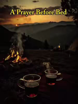 A serene outdoor scene at dusk, with a campfire in the foreground and a mountain range silhouetted against a sunset. Steam rises from two mugs set on the ground.