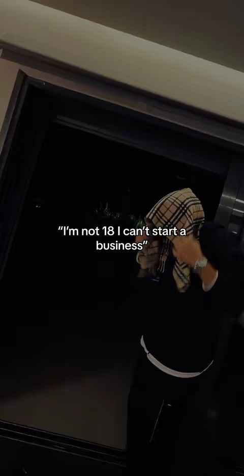 A person wearing a scarf over their head stands in front of what appears to be a dark doorway or opening. Text overlayed on the cover image reads, "'I'm not 18 I can't start a business.'"