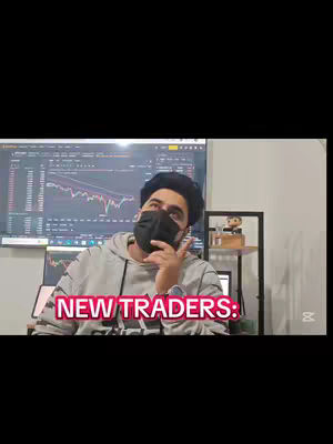 A man wearing a black mask and a gray hoodie is looking up, with a background of a computer screen displaying a chart and some shelves. The text overlayed on the bottom of the image says 'NEW TRADERS:'