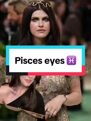 The cover image features a woman with dark hair and a headpiece. She is wearing makeup and jewelry, and a text overlay reads "Pisces eyes" with a Pisces symbol. A second woman is partially visible in the bottom left corner. The background is blurred, suggesting a public event with a green carpet.