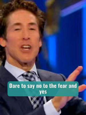 A man in a dark suit and tie is speaking with an open mouth and gesturing with his right hand. A teal rectangle with white text overlays the image.