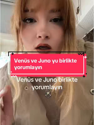 A woman with fair skin and light-colored hair is the central figure in a selfie-style video cover. She has a slightly open mouth as if in mid-speech and visible mascara outlining her eye. Overlaying her face is a red rectangle with white text that includes the phrase 'Venüs ve Juno'. Another text box below repeats part of the phrase. The background appears to be a light-colored interior. The overall composition is focused on the woman's face with distinct text overlays.