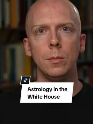 A bald, light-skinned man with blue eyes looks directly at the camera. The background includes a blurred bookshelf. A white banner at the bottom displays text about astrology.