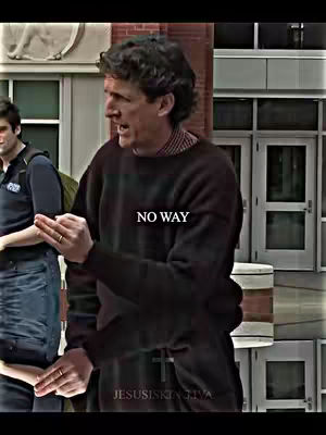 A man with curly hair is the main subject of the image. He's dressed in a dark sweater, and his right hand is near his face as he gestures. The words "NO WAY" are superimposed in white, centered on his chest. The background is blurred, suggesting an outdoor setting. The text "JESUSISKINGIVA" is at the bottom.