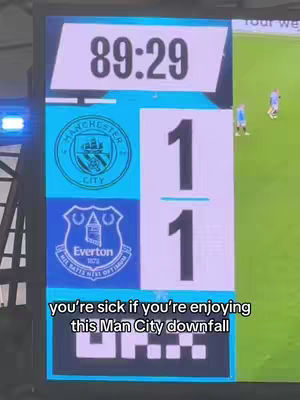 The cover image is a screenshot from a televised soccer match showing the scoreboard. The upper part of the image displays the time 89:29, the scores for Manchester City and Everton are 1-1. Below the score information are the team logos. At the bottom of the score are the words "you're sick if you're enjoying this Man City downfall". The color scheme used is blue and white.