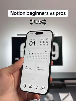 A hand holding a smartphone displaying a Notion interface. The phone screen is white with a clean layout displaying calendar widgets and app icons. In the background, a black panel displays the word "09" in large white numbers, a desk, and a wall.