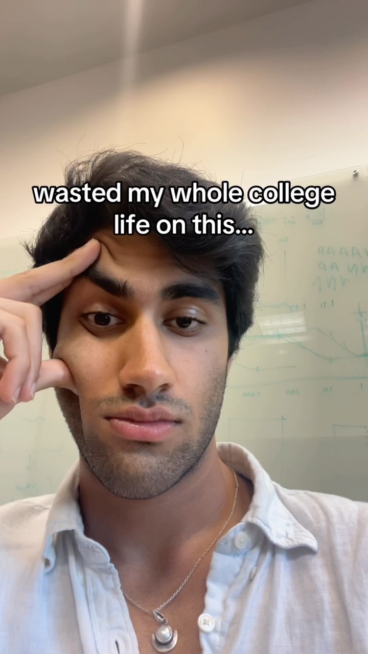 A close-up shot of a young man looking at the camera with a contemplative expression. He has dark hair, and a short beard. The text  overlayed. The background is blurry, suggesting an indoor office or studio setting.