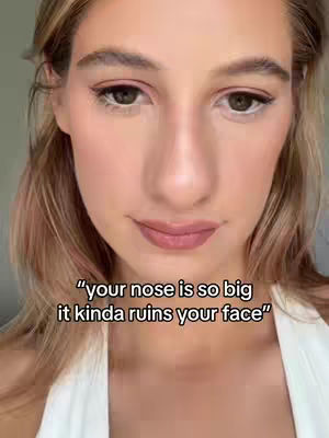A close-up shot features a woman with a fair complexion gazing directly at the camera. The lighting is soft and natural, creating a gentle glow on her face, with minimal background. The focus is clearly on her features, and her expression is one of gentle and slight smile. The text overlay adds an additional layer to the image.